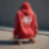 A vibrant red tie dye hoodie displayed on a skateboard, symbolizing the fusion of fashion and skate culture.