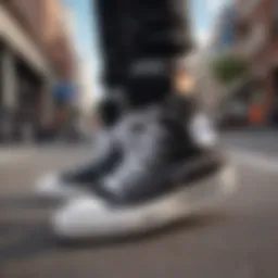 A close-up view of ladies black high top Converse shoes on a skateboard