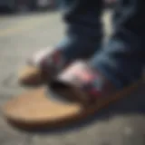 Close-up of Vans slide sandals on a skateboard