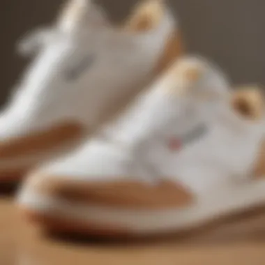 Close-up view showcasing the intricate details of Reebok white and tan shoes.