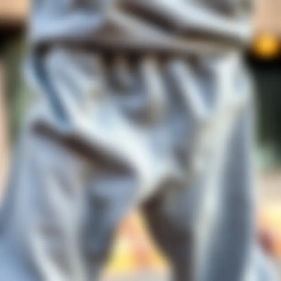 A close-up of baggy grey sweatpants showcasing their fabric texture and fit